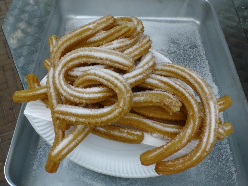 The image of Churros decorated with sugar powder