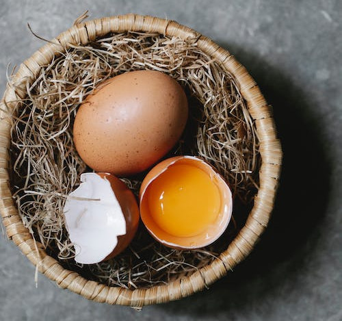 Eggs in a basket resemble a birdhouse.