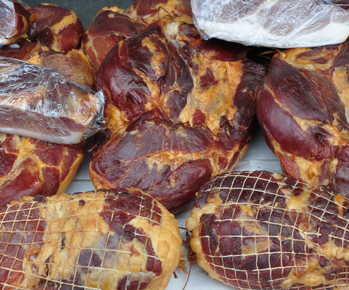 The image shows many salt cured hams