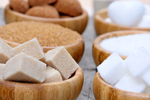 The image displays various types of sugar, including granulated, powdered, white, and brown sugars.