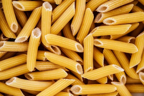 The image shows a pile of Penne pasta