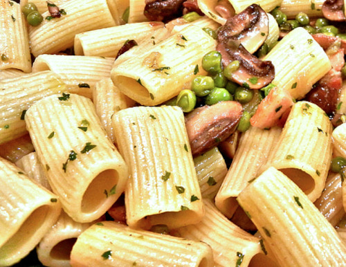 The image shows a pile of Rigatoni pasta being cooked