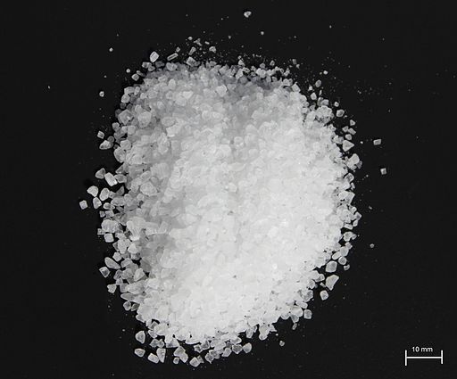 The image shows Sea salt on a black background