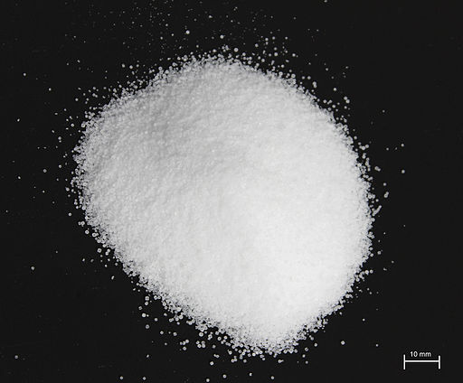 The image shows Table salt on a black background