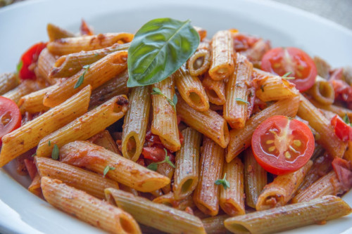 The image shows a dish of Tomato Basil Pasta