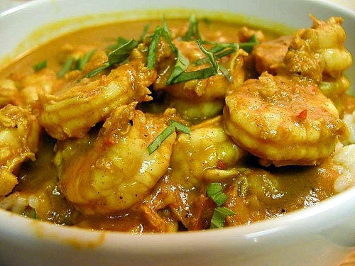 The images shows Coconut Shrimp Curry in the white bowl